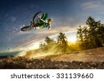 Dirt bike rider is flying high in evening