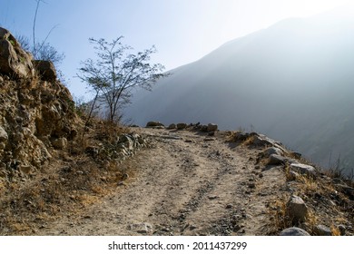 Dirt And Gravel Road With Mountain Background.