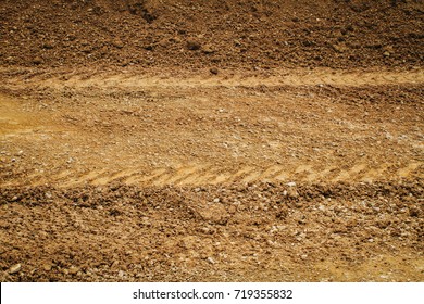 Dirt Gravel Road With Tire Tracks Texture At Construction Site.