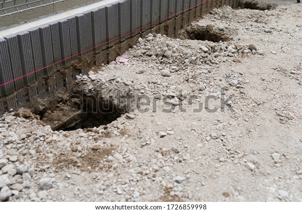 Dirt hole dug to drain\
concrete