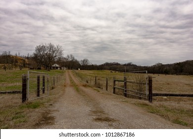 Dirt Lane Leading To A Traditional Beef Cattle Farm In Rural Appalachia Under Overcast Skies In January