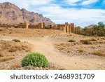 Dirt path to old ancient ruins of Tamnougalt village in desert landscape of Atlas Mountains, Morocco, North Africa