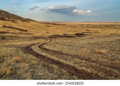 dirt ranch road in grassland in northern Colorado, early spring scenery of Soapstone Prairie Natural Area near Fort Collins