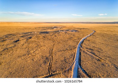 dirt ranch road  in Pawnee National Grassland in northern Colorado, fall or winter scenery, aerial view - Shutterstock ID 1026165784