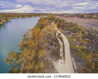 Dirt Road Among Gum Trees Along Murray River - Aerial View