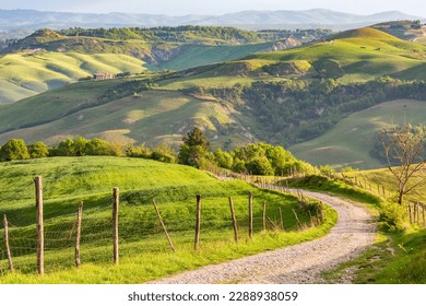 Dirt road down into the valley in a rural culture landscape - Powered by Shutterstock