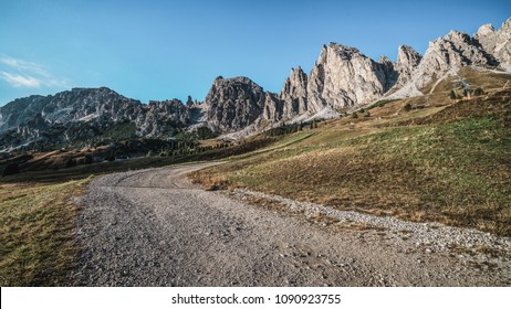 Dirt road and hiking trail track in Dolomites mountain, Italy, in front of Pizes de Cir Ridge mountain ranges in Bolzano, South Tyrol, Northwestern Dolomites, Italy.
