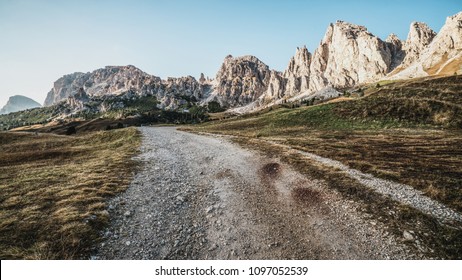 Dirt road and hiking trail track in Dolomites mountain, Italy, in front of Pizes de Cir Ridge mountain ranges in Bolzano, South Tyrol, Northwestern Dolomites, Italy. - Shutterstock ID 1097052539