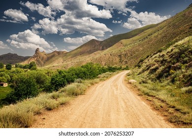 dirt road in the middle of a desert area in the mountains. Beautiful and picturesque landscape