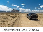 Dirt road near Hanksville, southern Utah, with Factory Butte in the background.