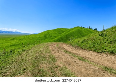 Dirt road on the mountain. Road and green mountain natural background. - Powered by Shutterstock