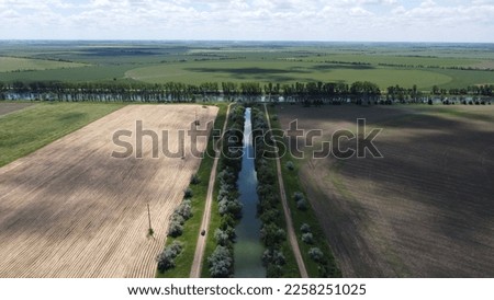Dirt road. River junction, dam, fields. High quality aerial photo