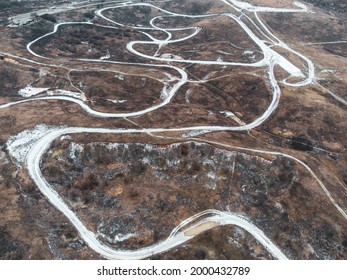 Dirt Trail Race Track Road Aerial Photo In Winter With Covered In Snow Lines. Outdoor Sport Racing Terrain Pattern