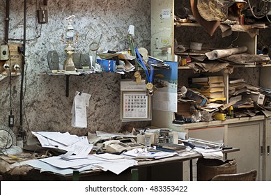 dirty and abandoned office with books and papers