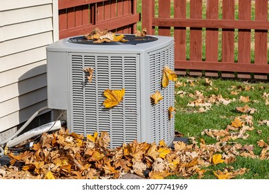 Dirty Air Conditioning Unit Covered In Leaves During Autumn. Home Air Conditioning, HVAC, Repair, Service, Fall Cleaning And Maintenance Concept.