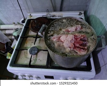 A Dirty Aluminum Pan Stands On A Gas Hob.