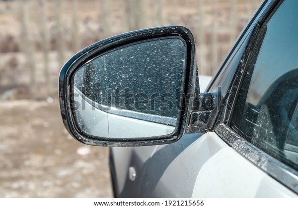 Dirty auto side mirror\
close-up.