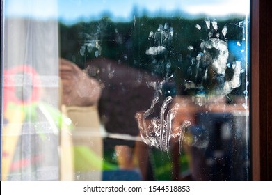 Dirty Baby Hand Prints On The Window Glass