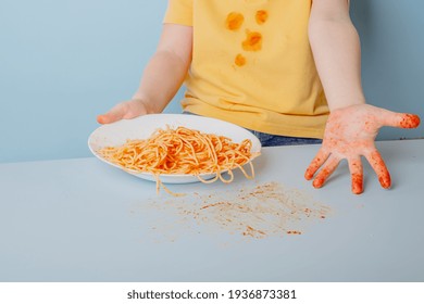 Dirty Baby Hands From Tomato Spaghetti Sauce Bolognese. Concept Of Dirty Stains On Clothes. High Quality Photo