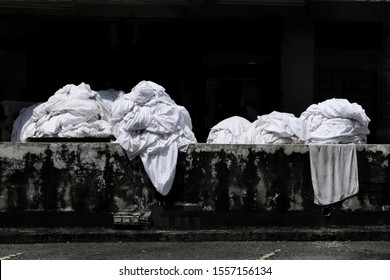 Dirty Bedsheets And Linens From Nearby Budget Hotels And Inns Are Being Gathered And Sorted Out At The Back Of A Commercial Dry Cleaning Shop To Be Washed And Cleaned.