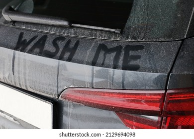 A Dirty Black Car Says Wash Me