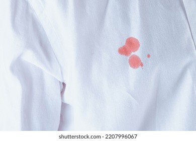 Dirty Blood Stain On White Clothes. Isolated. Daily Life Stain Concept. High Quality Photo 