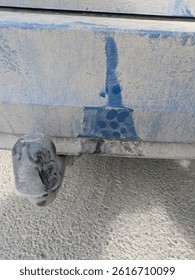 Dirty blue car with small damage on bumber. Small mark on blue car after hit by motorcycle.