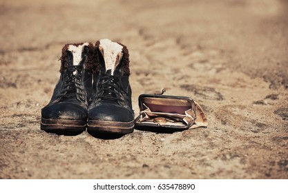 Dirty Boots And Wallet On The Street