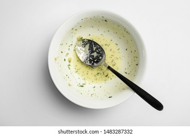 Dirty Bowl With Food Leftovers And Spoon On White Background, Top View