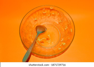 Dirty Bowl With Leftovers Food (noodles) And Spoon. Top View