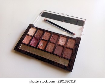 Dirty And Broken Eyeshadow Palette Isolated In White Background.