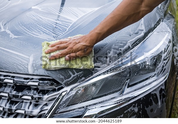 dirty car being washed by\
day