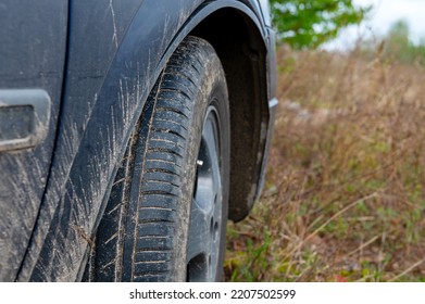 Dirty Car Front Wheel. The Front Wheel Of A Dirty Car In The Sand