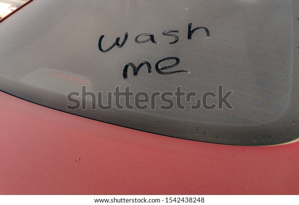 Dirty car getting washed.Washing the dirty car\
manually in a car wash\
shop