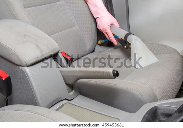 Dirty car interior light gray textile seats\
chemical cleaning with professionally extraction method. Early\
spring cleaning or regular clean\
up.