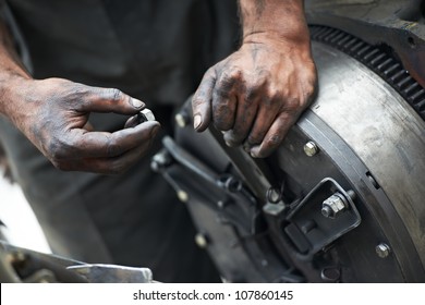 Dirty Car Mechanic Hands Examining Car Automobile At Repair Service Station