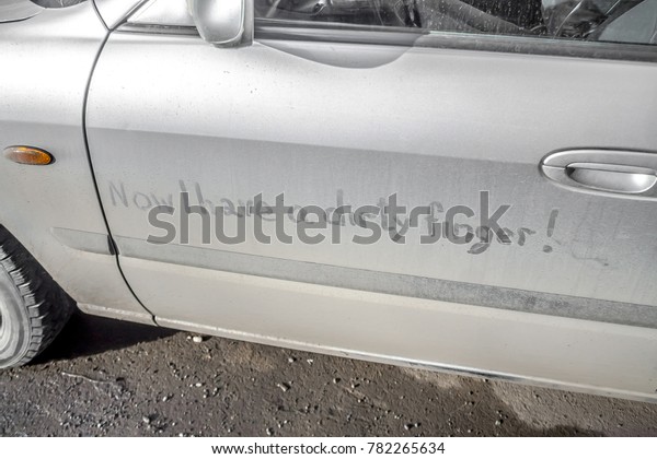 Dirty car on the street with the inscription Now\
I have a dirty finger.