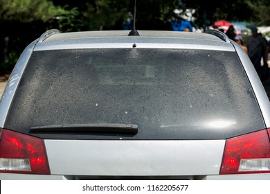 dirty car rear view wagon crossover rear window covered with a layer of dust.