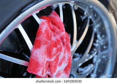 The Dirty Car Rim Is Foamy Cleaned With A Rag