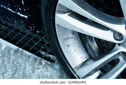 Dirty Car Rim Wheel At A Self-wash Car Station. Detail View Of The Rim With Oil Dirt On It.