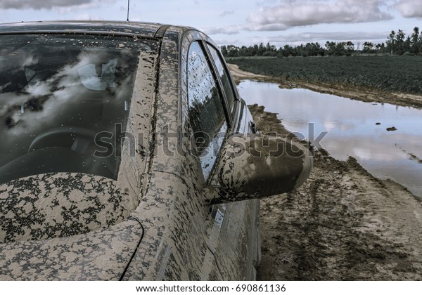Dirty Car stuck in\
swamp. Off road trip