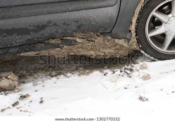 Dirty car tire with\
snow. Chemical reagents
