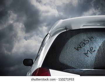 a dirty car waiting under dark cloud and to be washed