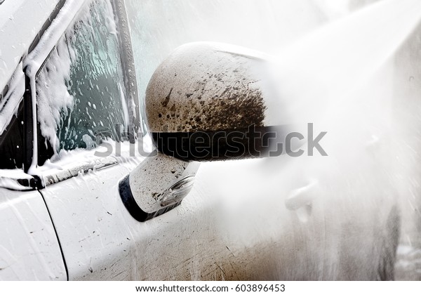 \
 Dirty car wash high pressure\
water. Car shampoo, foam, no contact car wash. White\
car.