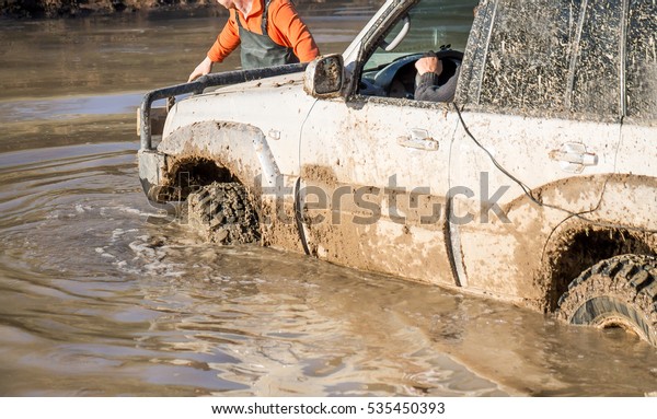 dirty car in the water at\
the races