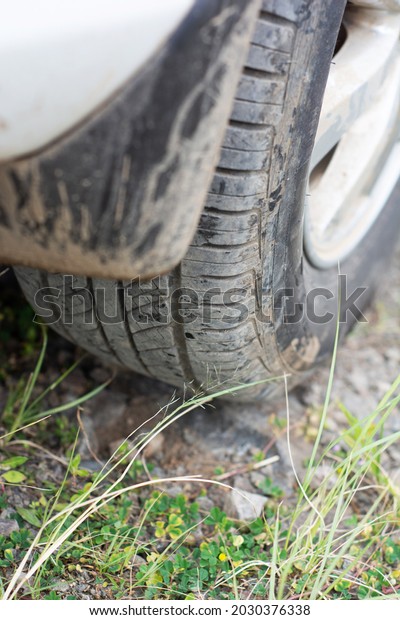 Dirty car wheels on the\
grass