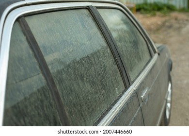 Dirty Car Window. Dust On Vehicle Glass. Car In The Parking Lot In Summer. Dusty Machine Surface.