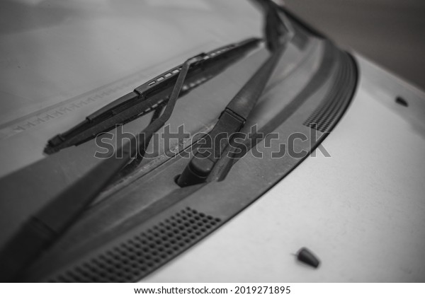 Dirty car window with a\
wiper blade 