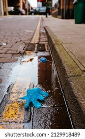 Dirty City Streets With Litter Dumped By The Road Side Low Angle View With Perspective Along The Road And Yellow Road Lines