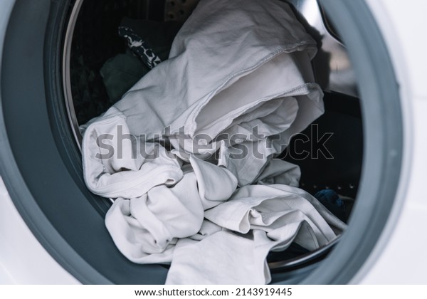 Dirty\
clothes in washing machine. Washing machine\
loading